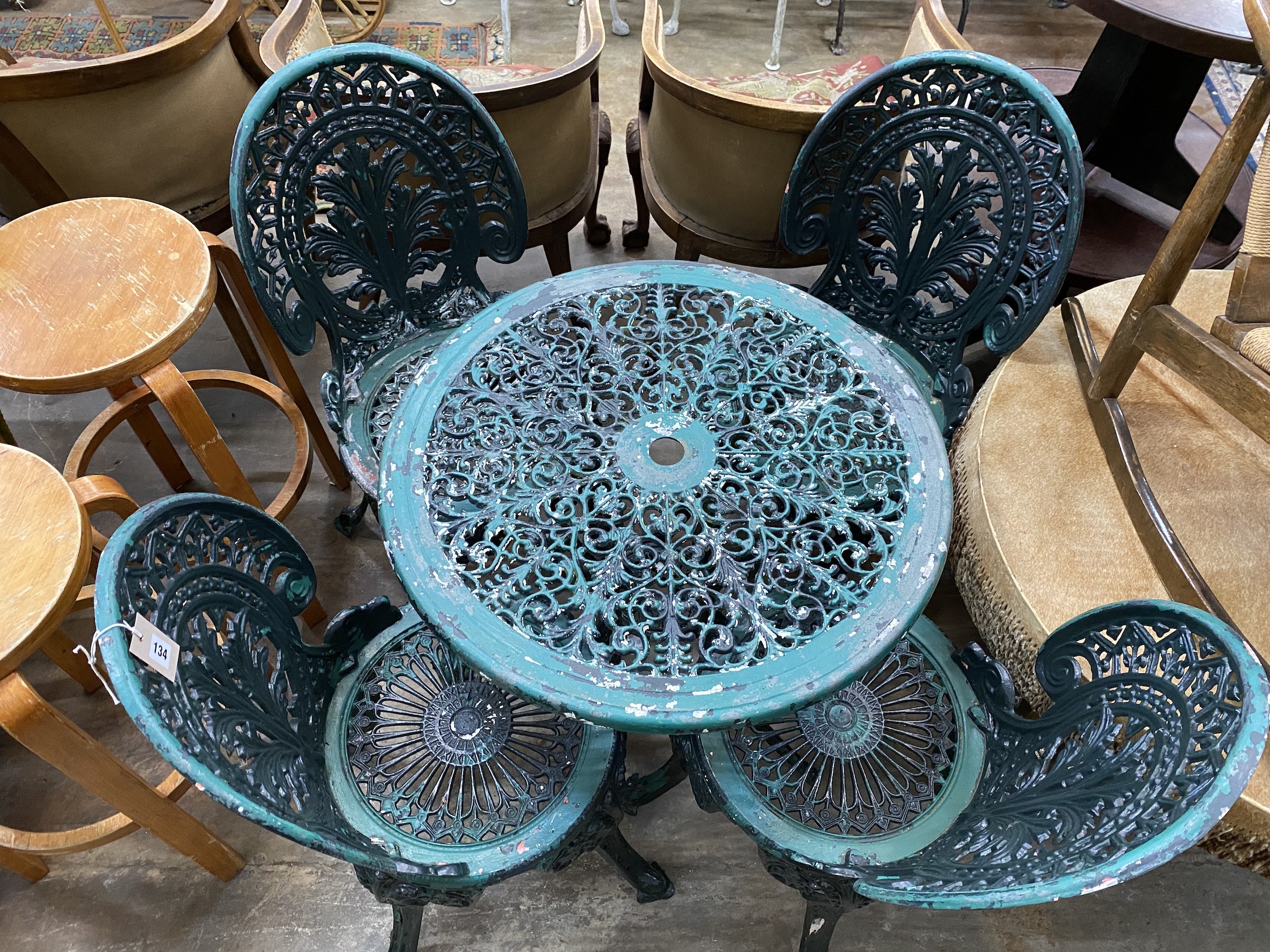 A circular painted aluminium garden table, diameter 66cm, height 65cm, together with four chairs